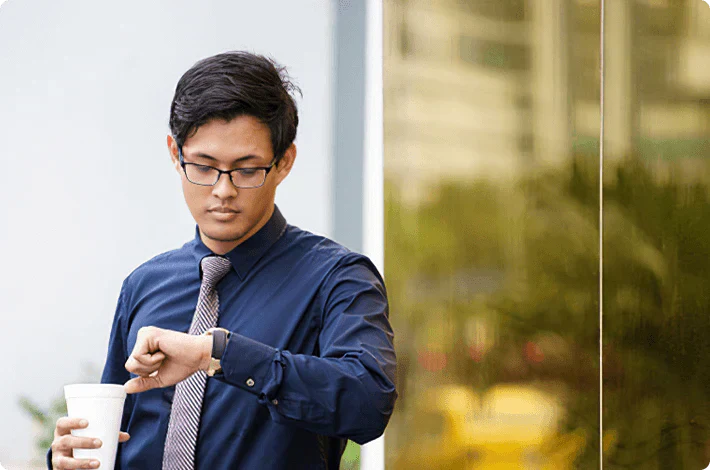 Man looking at watch to manage time