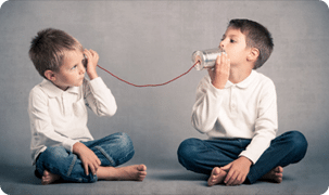two kids talking through cans
