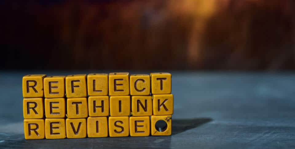 stacked blocks show the words: Reflect. Rethink. Revise.