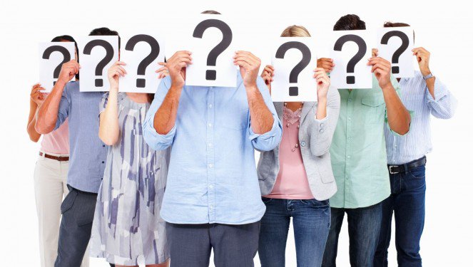 adults holding up question marks in front of their faces