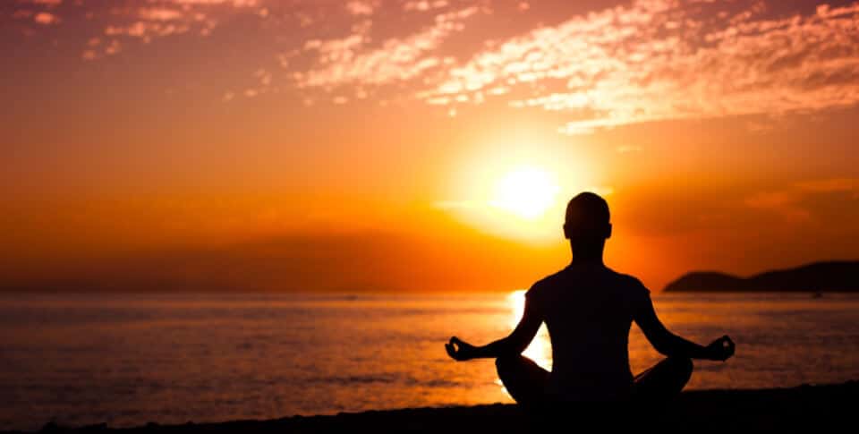 yoga pose in front of a sunset