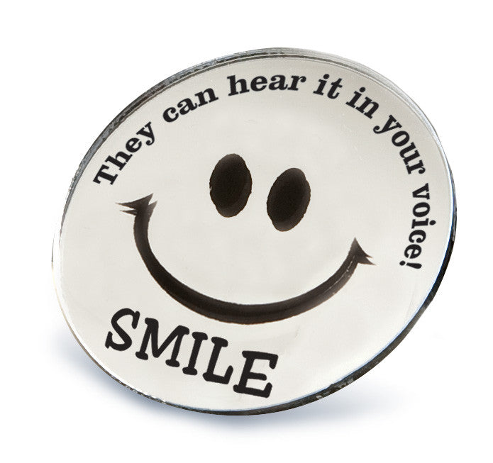 Round Smile Mirror imprinted with "SMILE. They can hear it in your voice."