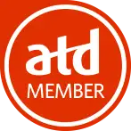 Red circular logo with white ’atd member’ text.