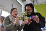 We Connect Cards - Conversation Deck - Trainers Warehouse - two players examing and sharing the three cards they each picked.